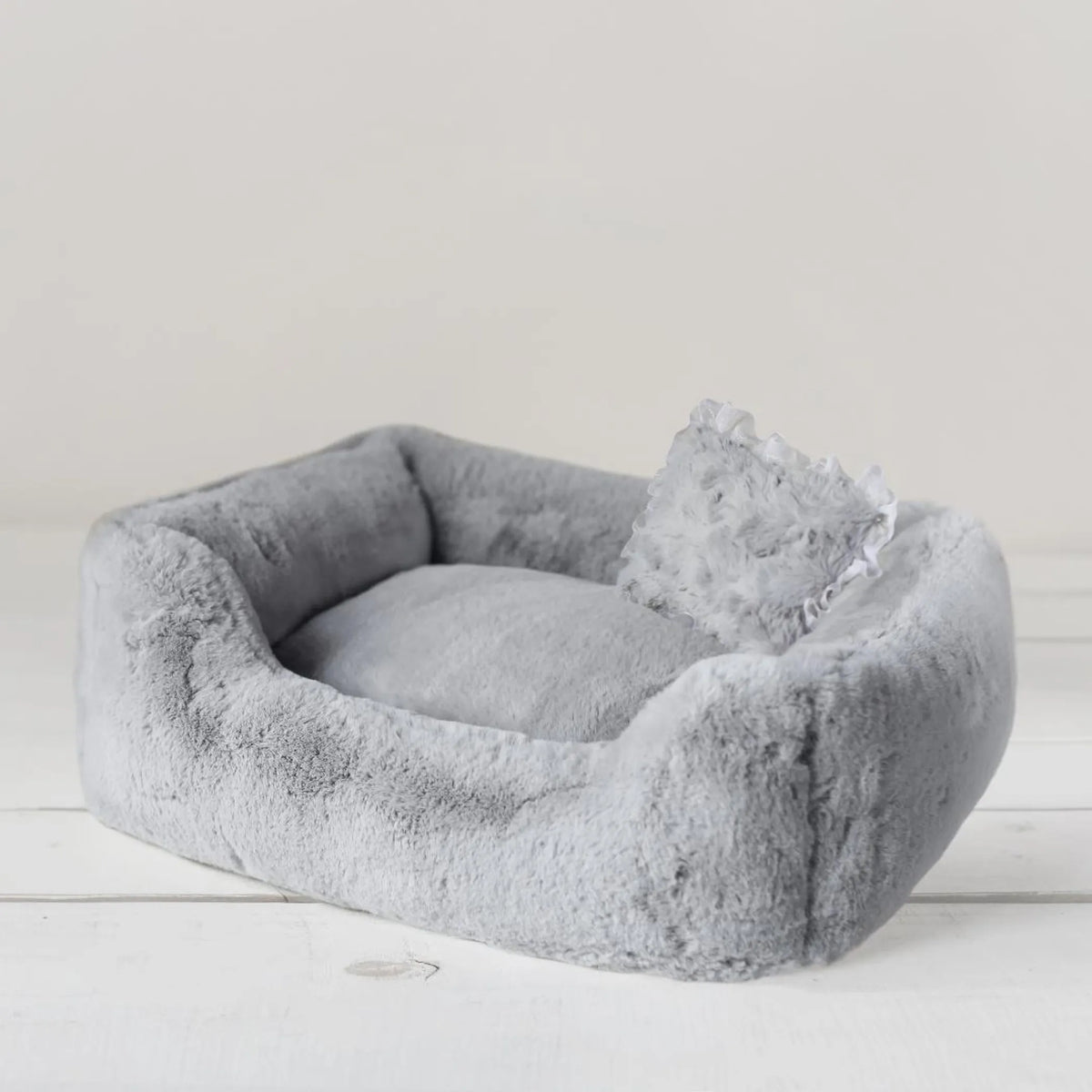 Divine bolster dog bed in Dove grey with its overstuffed center pillow