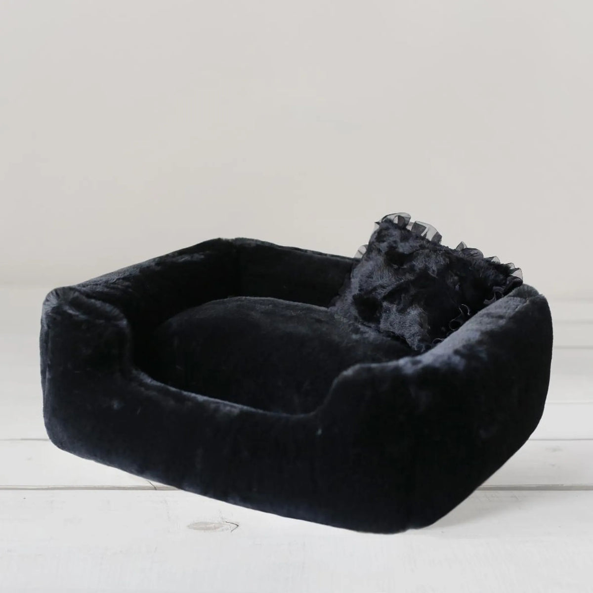 Divine luxury bolster dog bed for small dogs in Dove grey, showing the low scooped front and overstuffed center pillow
